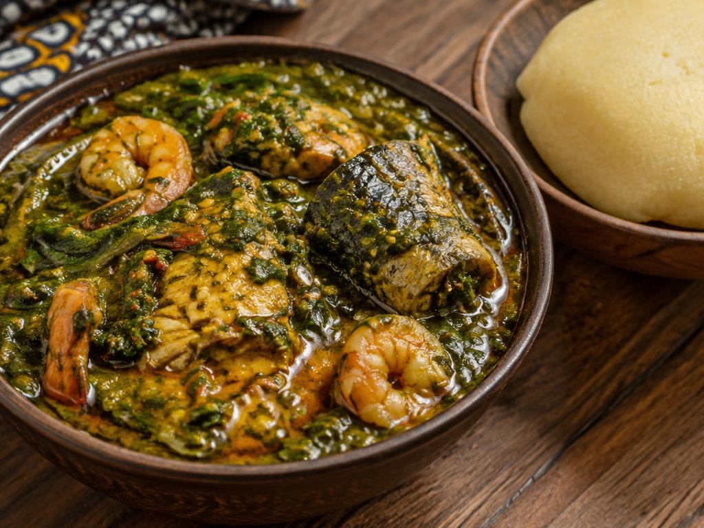 Nigerian okra soup with prawns and fish, served with eba