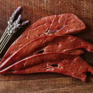 Sliced liver with sprigs of lavender.
